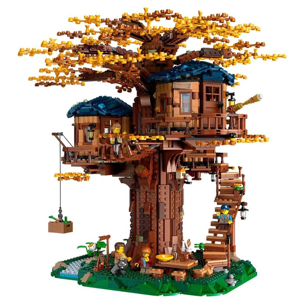 LEGO Ideas Tree House 21318 set fully built with detailed tree canopy, wooden-style house, and minifigures on a display platform