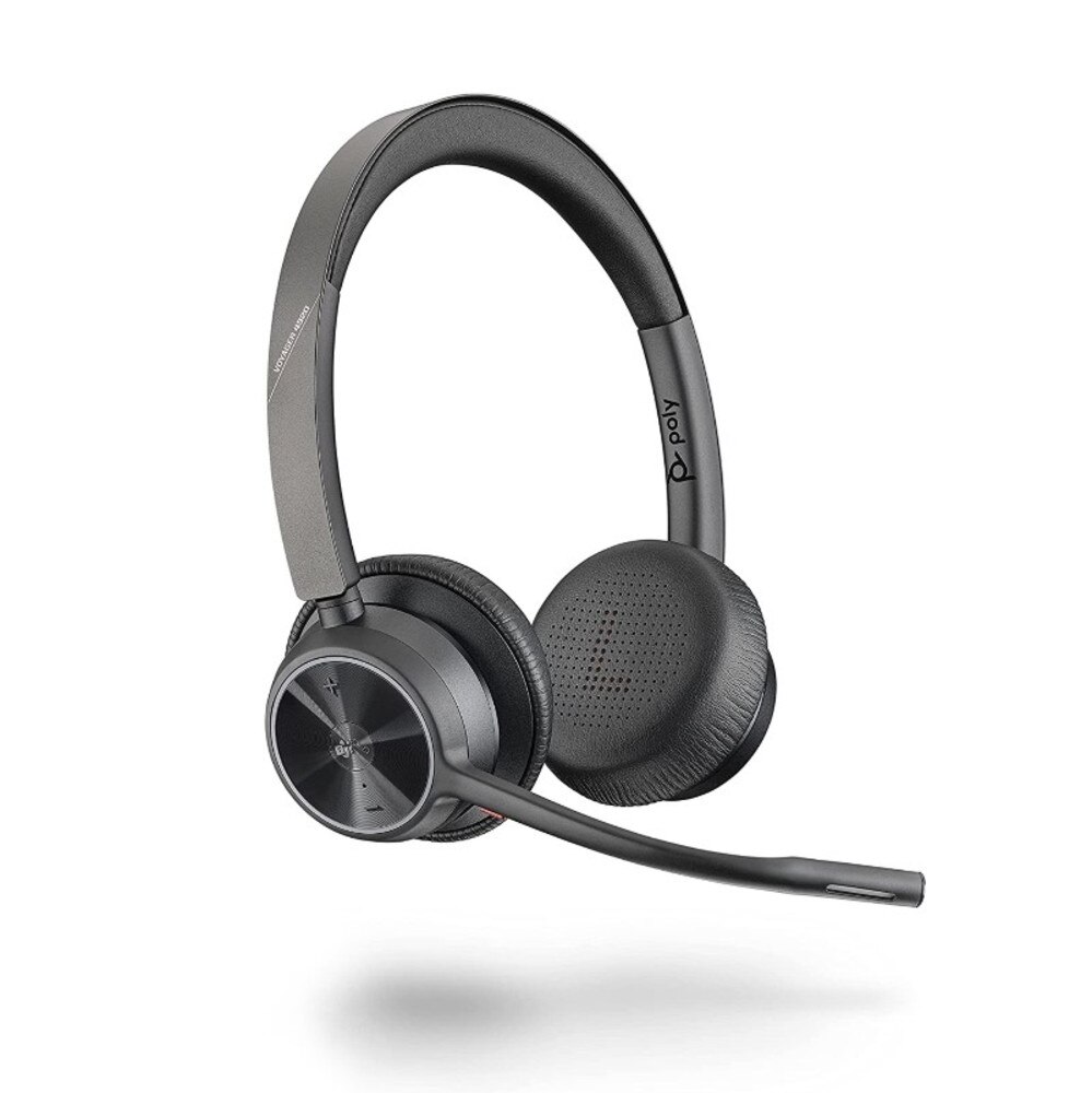 A photo of a Plantronics Voyager 4320 UC MS Teams USB-C wireless headset with a charging stand and a USB-C adapter.