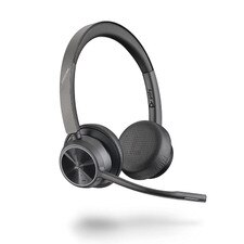 A photo of a Plantronics Voyager 4320 UC MS Teams USB-C wireless headset with a charging stand and a USB-C adapter.