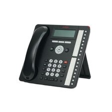 A photo of a black phone with a large display and a number pad on the front, and multiple ports on the back. The phone has a silver stand that allows it to be tilted at different angles. The phone is