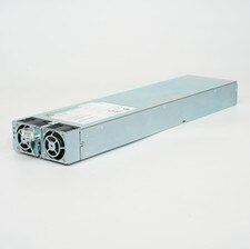 A Cisco ASR 9000 Series Power Supply PWR-2KW-DC-V2. It is a silver rectangular device with a fan and a power cord. It is used to provide power to the Cisco ASR 9000 Series routers.